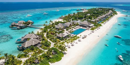 Aerial view of a luxury tropical resort with turquoise waters